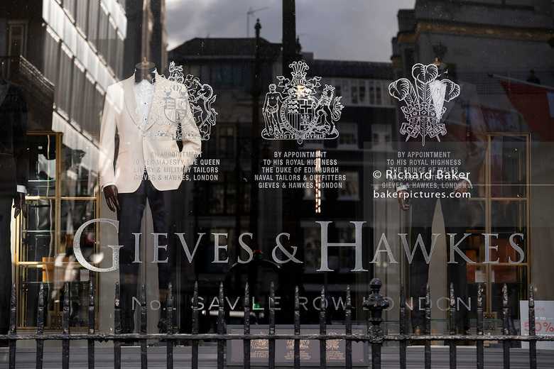 a Gieves & Hawkes store window with a mannequin, wearing one of their suits