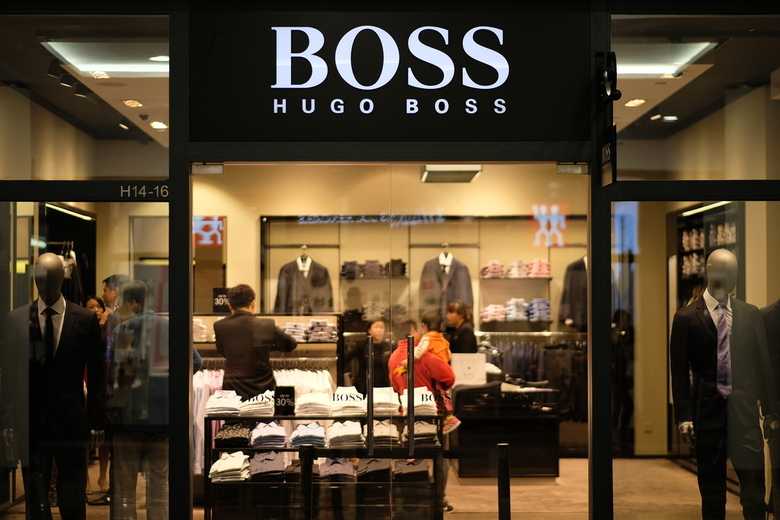 a Hugo Boss store window, showcasing their suits collection