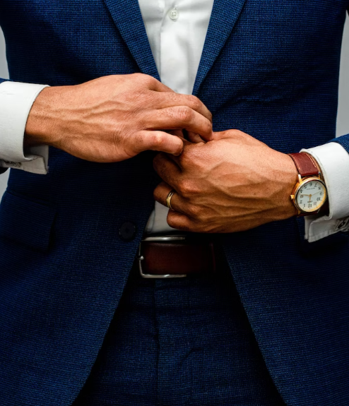 a man buttoning up his suit jacket