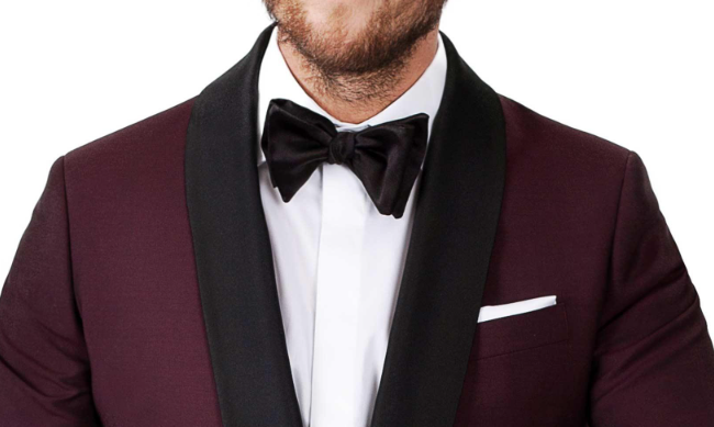 A black bow tie on a burgundy dinner suit